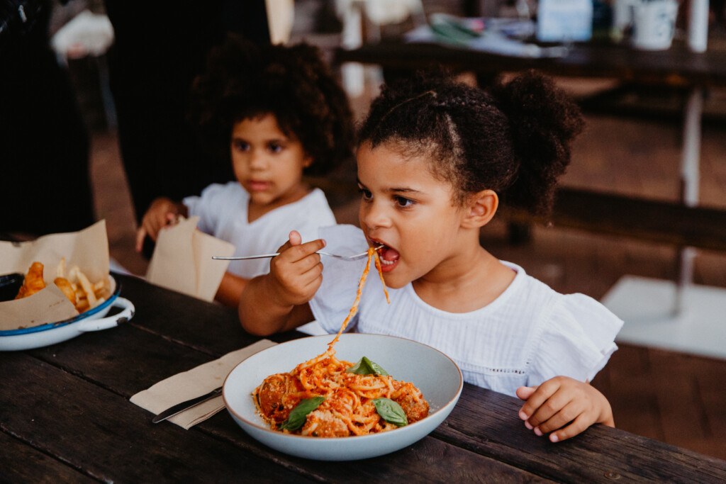 Kids eating spaghetti at Bistro