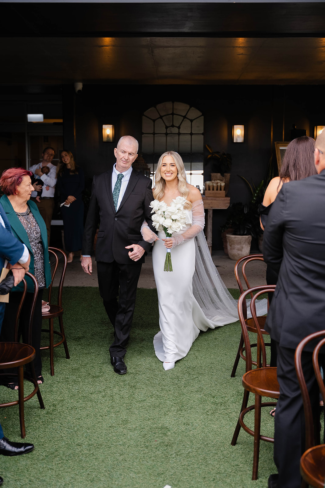 Bride walks down the aisle with father.