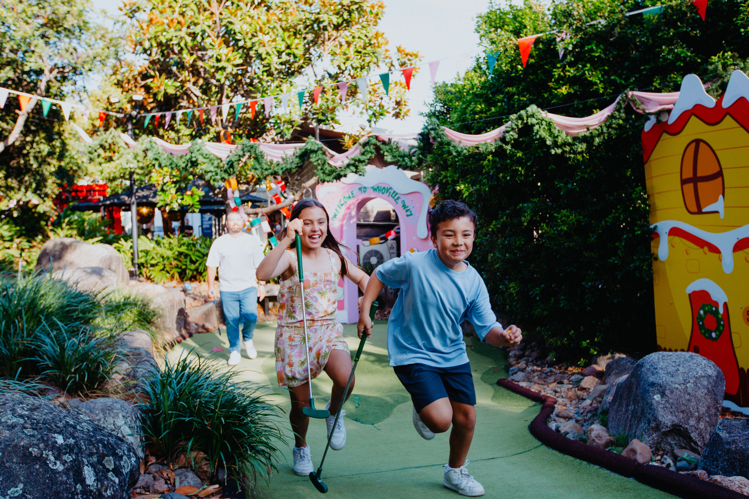 Kids running on Christmas Putt Putt course